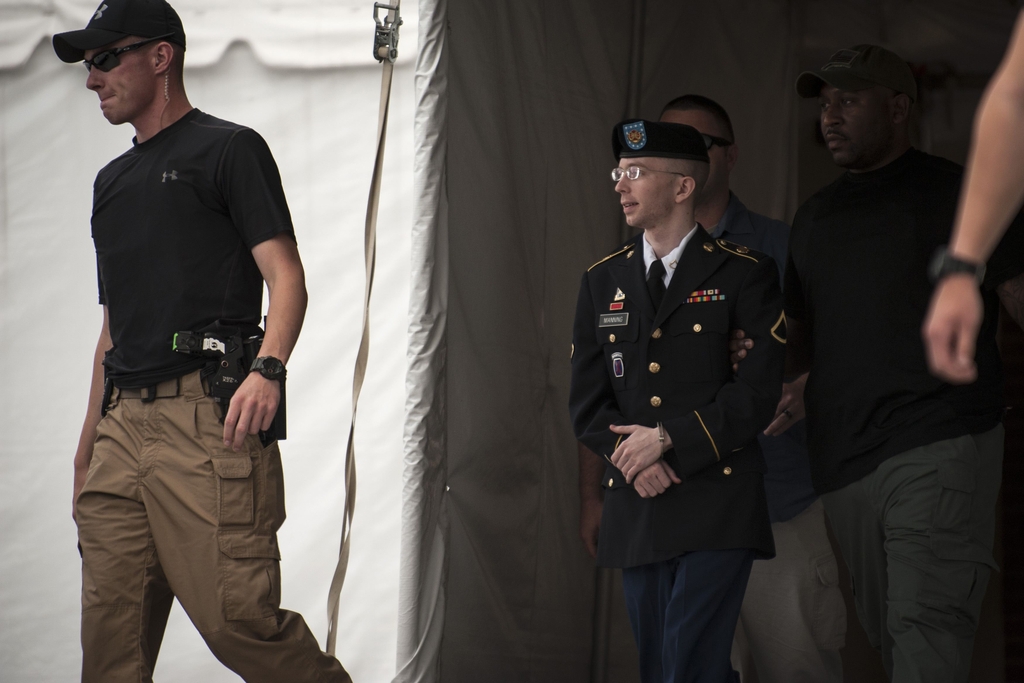 Bradley Manning is escorted out of court after hearing the verdict in his military trial at Fort Meade, Maryland