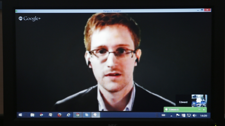 Edward Snowden is seen on a screen as he speaks via video conference with members of the Committee on Legal Affairs and Human Rights of the Parliamentary Assembly of the Council of Europe during an hearing on "mass surveillance" in Strasbourg, April 8, 2014.