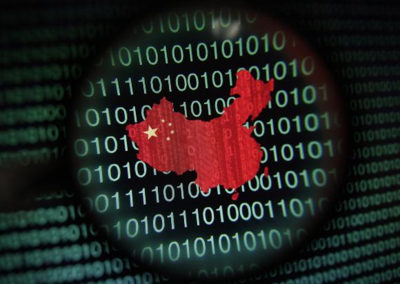 A map of China is seen through a magnifying glass on a computer screen showing binary digits in Singapore in this January 2, 2014 photo illustration. Picture taken January 2, 2014. REUTERS/Edgar Su