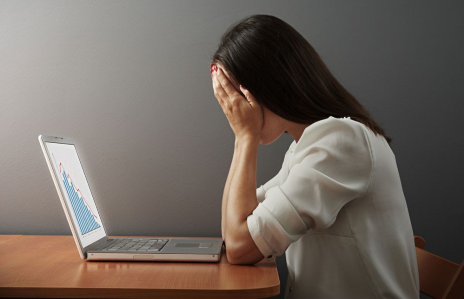 "depressed woman covering her face by the hands over dark wall," Shutterstock.