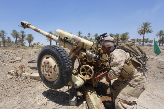 Iraqi security forces fire artillery during clashes with Sunni militant group Islamic State of Iraq and the Levant (ISIL) in Jurf al-Sakhar June 14, 2014. REUTERS/Alaa Al-Marjani