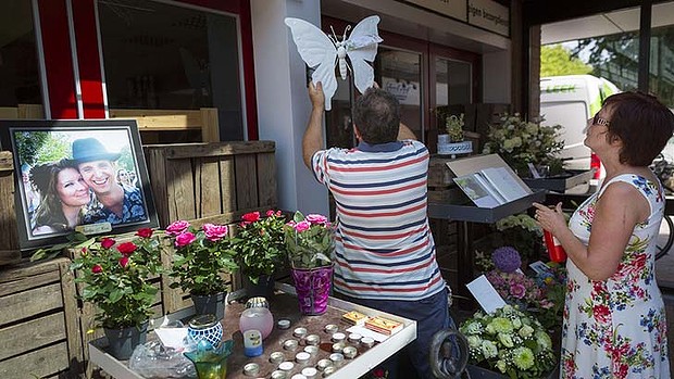 Mourners outside the shop where one of the Malaysia Airlines crash victims used to work. Photo: Reuters.