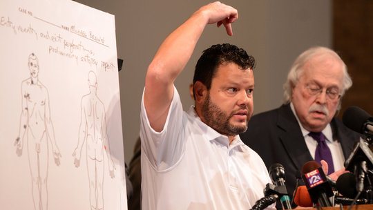 Shawn Parcells pointing to the part of his body where brains are supposed to be found.