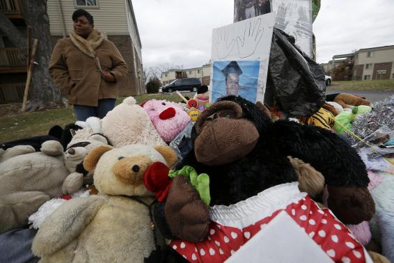 A woman looks at the memorial set up at the site of the shooting death of Michael Brown in Ferguson