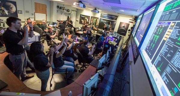 The New Horizons team at work, after a successful Pluto encounter. Photos: NASA