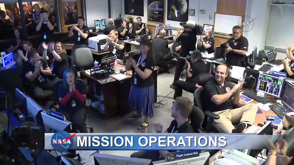 Cheers and clapping at the Mission Operations Center (MOC), where the New Horizons spacecraft signal was received.